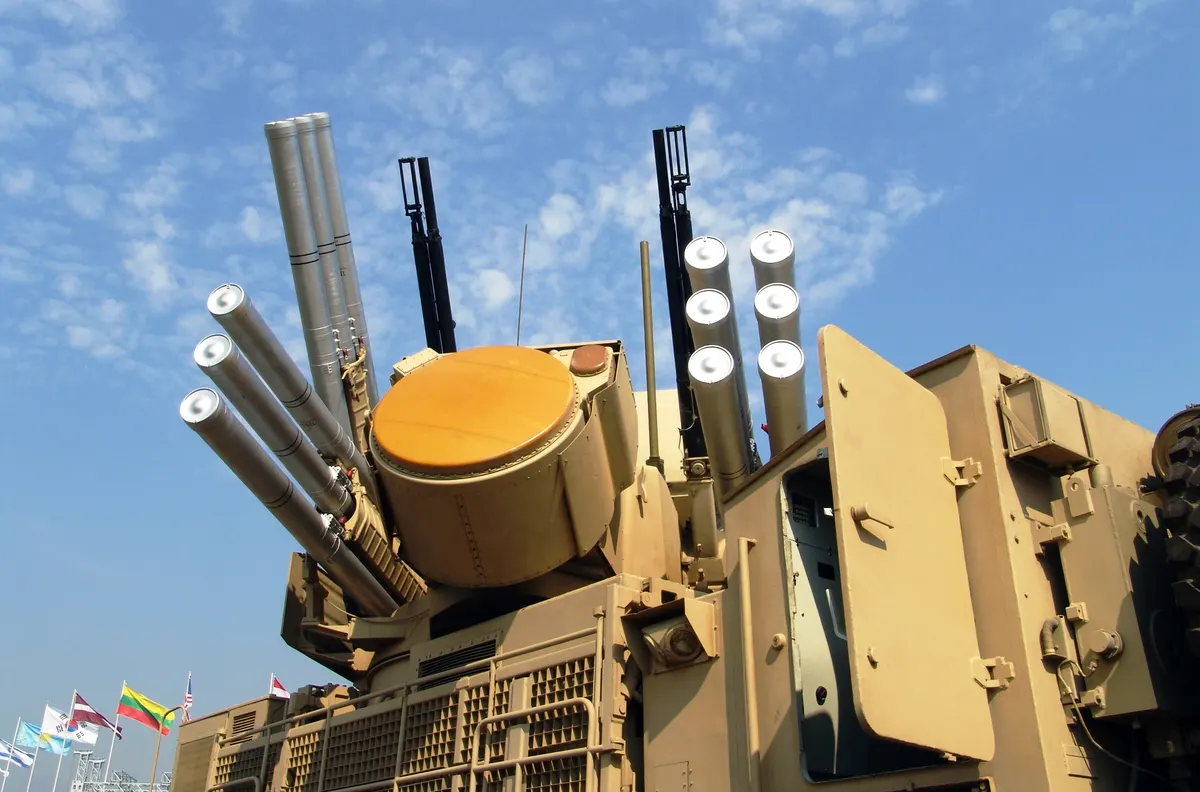Mobile short range air defense radar and gun vehicle