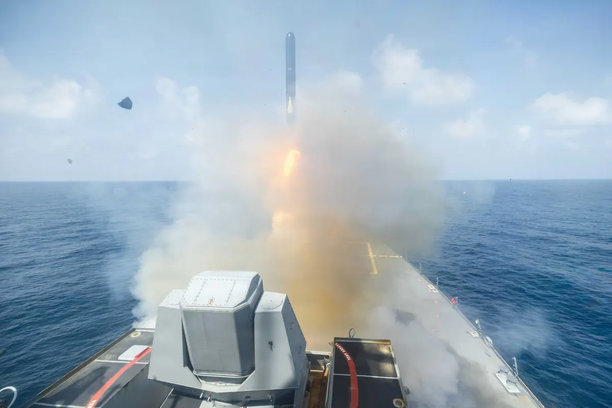US Navy destroyer launching a Tomahawk cruise missile at sea