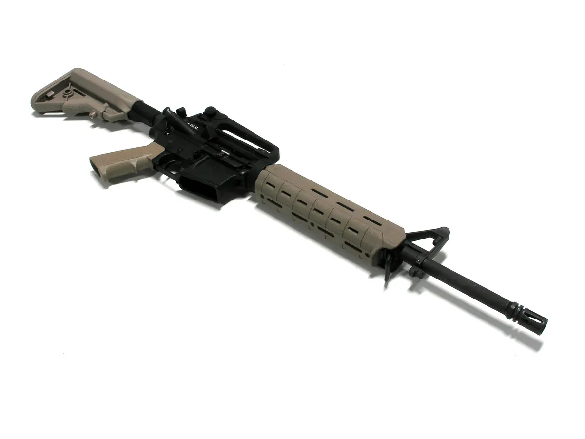Close-up of an M-LOK rifle handguard showing its slotted mounting interface