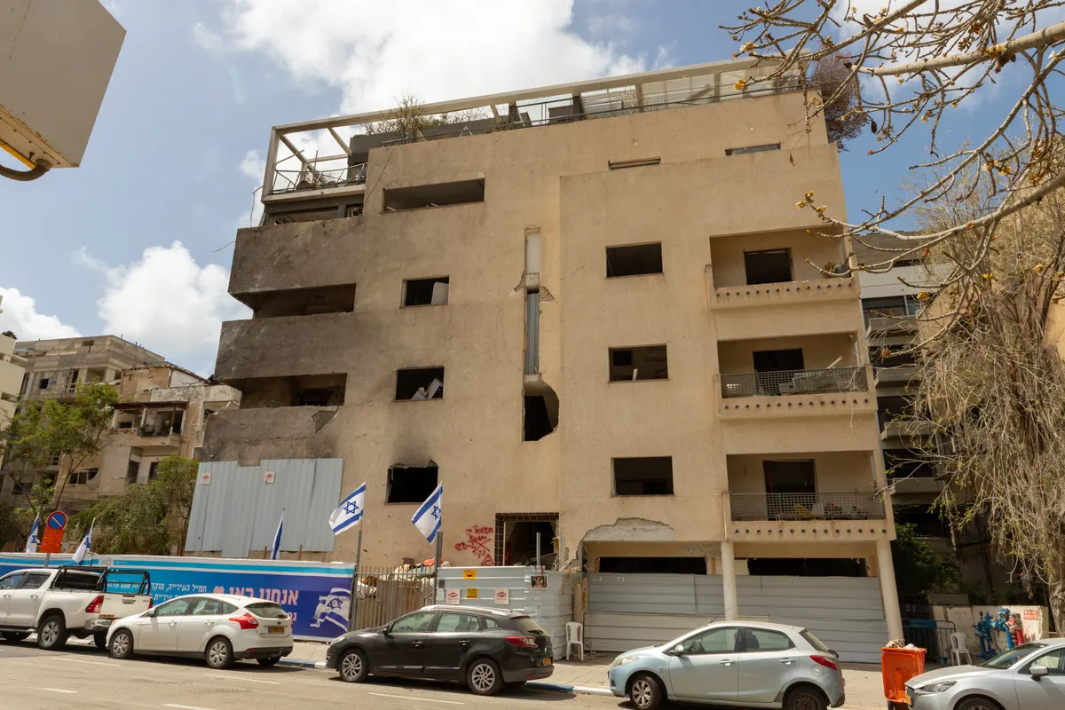 Building damage from a missile impact in an Israeli city
