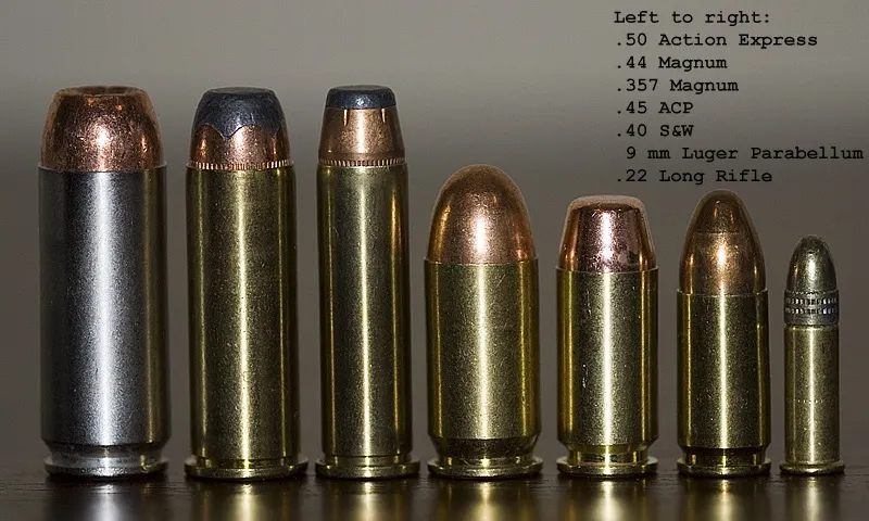 .44 Remington Magnum cartridges next to a revolver cylinder
