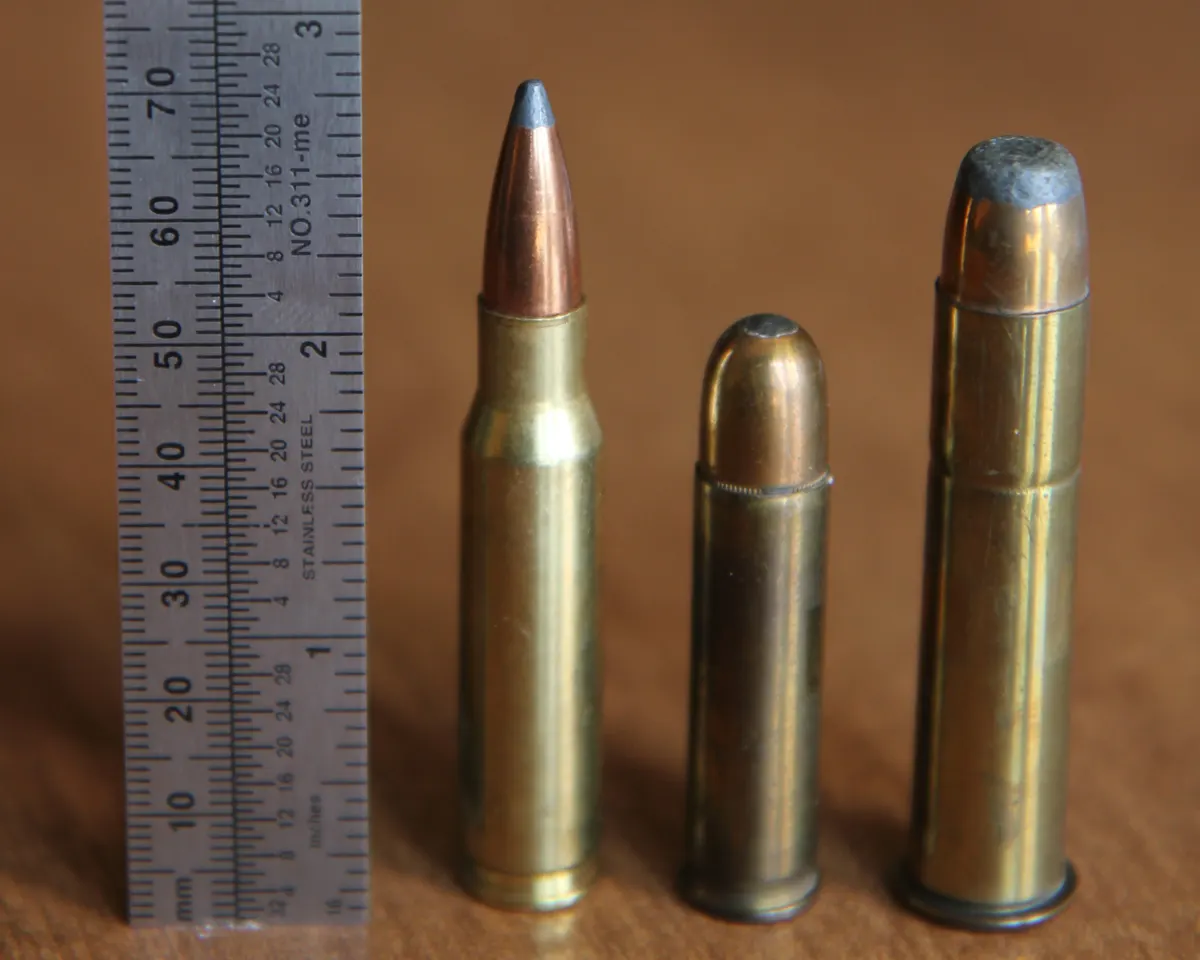 .308 Winchester rifle cartridge on a plain background