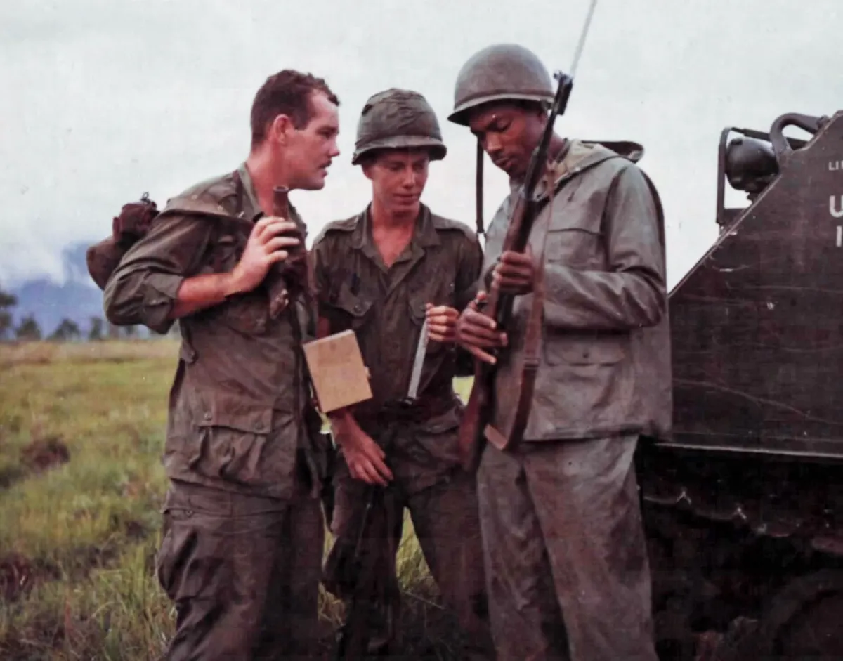 US soldiers examining a captured SKS carbine